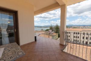 a balcony with a view of a city at Marysel Rooms in Olbia