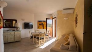 a living room with a couch and a table at Appartamento Due passi dal Mare - La Marmorata in Santa Teresa Gallura +19 photos