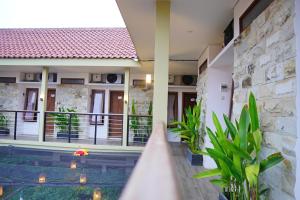 a villa with a swimming pool in a resort at Sandy's Homestay in Banyuwangi