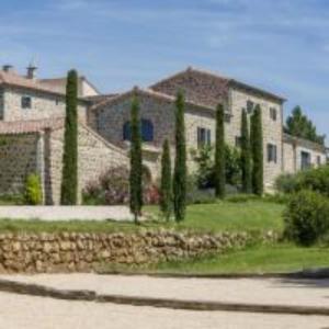a house with a bunch of trees in front of it at Le Mas de Baume in Rosières +10 photos
