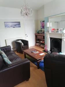 a living room with a couch and a table at Dales View House in Barnoldswick