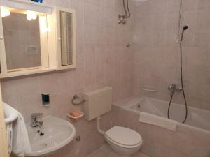a bathroom with a toilet and a sink and a tub at Villa Jasmin in Bol