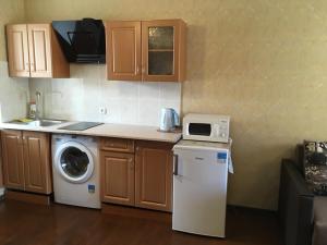 a kitchen with a washing machine and a washer at Уютная квартира метро Защитников Украины in Kharkiv