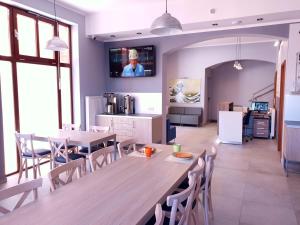 a kitchen and dining room with a table and chairs at Hostel Annamarie in Szczecin