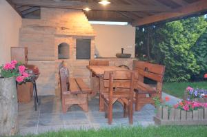 a patio with a table and chairs and a pizza oven at penzion U Koníčka in Strážiště