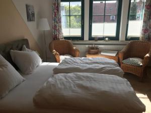Ein Bett oder Betten in einem Zimmer der Unterkunft Schippers Butz strandnah mit Whirpool