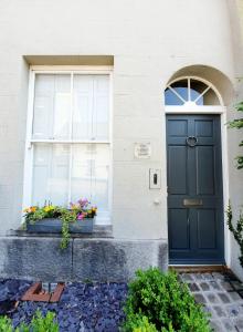 a house with a black door and a window at The Butler's House in Ulverston