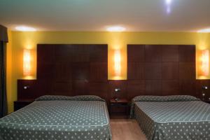 Cama o camas de una habitación en Motel Emporio