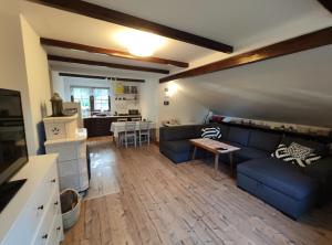 a living room with a couch and a table at Dom Nad Jeziorem in Szteklin +14 photos