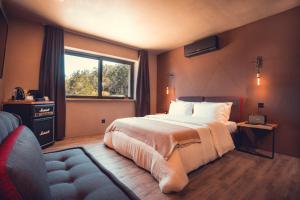 a bedroom with a large bed and a window at Charm Nature in Azoia