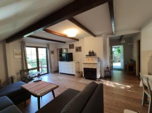 a living room with a couch and a fireplace at Dom Nad Jeziorem in Szteklin