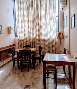 a dining room with tables and chairs and a large window at Hotel Ionio in Katakolo