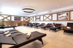 a large waiting room with chairs and tables at Elto Appartements Chalet in Kaprun