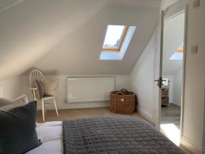 a attic bedroom with a bed and a skylight at No11 in Lewes