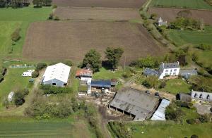 an aerial view of a farm with a white house at Les chambres d'hotes du cosquer in Beuzec-Cap-Sizun