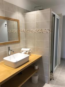 a bathroom with a white sink and a mirror at Hôtel du Golfe in Bonifacio +35 photos