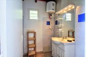 a bathroom with a sink and a mirror at Domaine De Berard in Sainte-Anne