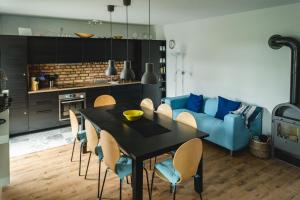 a living room with a table and a blue couch at Das Sterf in Willershagen