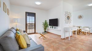 a living room with a couch and a table at Villa Elena in Lajares