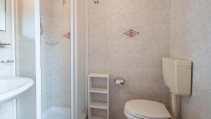 a bathroom with a toilet and a sink and a shower at Welcomely - Isole Apartments in Olbia +44 photos