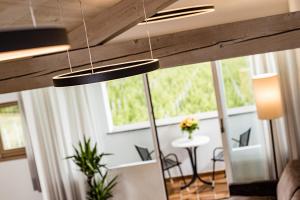 a living room with two lights hanging from the ceiling at Apartments Seewinkel in Caldaro
