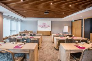 a dining room with tables and chairs and a podium at Crowne Plaza Istanbul Oryapark by IHG in Istanbul