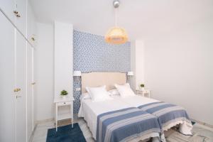 Postel nebo postele na pokoji v ubytování Arco Macarena Suite