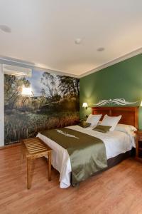 a bedroom with a bed and a painting on the wall at Hotel La Barrosa in Abejar