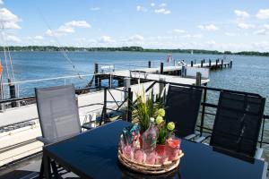 a table on a boat on the water at Island-dreams Hausboot Cecilie in Schleswig