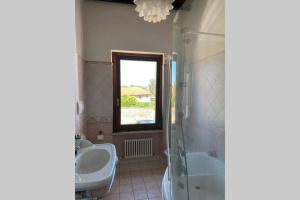 a bathroom with two sinks and a shower and a toilet at Casa di Adele in Chiaravalle