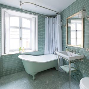 uma casa de banho verde com uma banheira e um lavatório em The Stay Well em Boulogne-sur-Mer