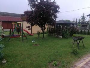 a yard with a playground and a swing at Zajazd agroturystyczny KA-JA in Kiełkowice