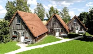 two barns with white doors on a green field at Fränkischer Ferienhof Joas in Gerolfingen