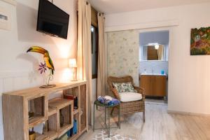 a living room with a tv and a chair at Villa La Perla in Candelaria