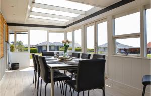 a dining room with a table and chairs and windows at Amazing Home In Slagelse With Wifi in Slagelse