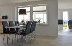 a dining room with a table and black chairs at Amazing Home In Slagelse With Wifi in Slagelse