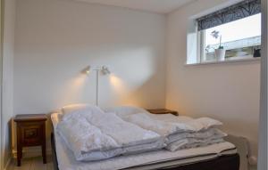 an unmade bed in a bedroom with a window at Amazing Home In Slagelse With Wifi in Slagelse
