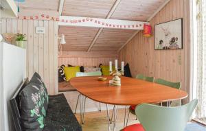 a dining room with a wooden table and chairs at 2 Bedroom Lovely Home In Sæby in Sæby