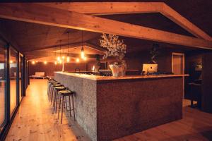 a large kitchen with a bar with stools at Charm Nature in Azoia
