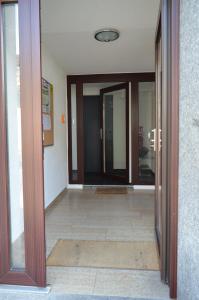 an open door of a building with a hallway at Pension Zur Traube in Bergheim