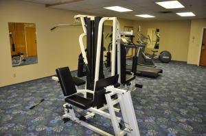 a gym with several tread machines in a room at Tropical Inn - North Battleford in North Battleford