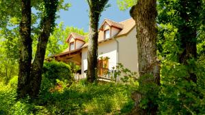 a house in the woods with trees at Domaine de Gayfié in Salvagnac-Cajarc