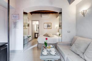 een woonkamer met een bank en een bed bij Rome Frattina27 in Rome