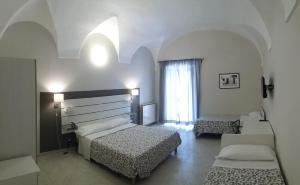 En eller flere senge i et værelse på HOTEL MALIBU