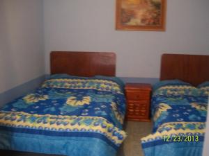 Postel nebo postele na pokoji v ubytování Hostal Eclipse Oaxaca