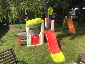 a group of playground equipment in the grass at Pensjonat Lazur in Mielno