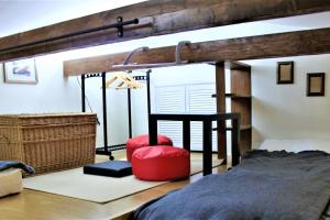a bedroom with a bunk bed and a red chair at PrivOffice4U Samurai - Old Town, Main Square, Main station in Krakow