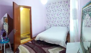 a small bedroom with a bed and a mirror at House Fox in Iraklitsa