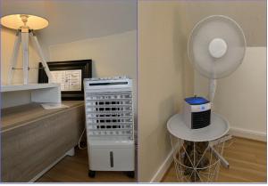 a room with a fan and a table with a desk at Appartement agreable et zen in Boulogne-sur-Mer