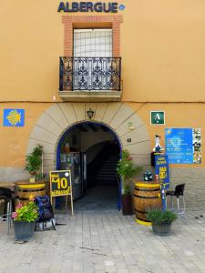 uma entrada para um edifício com uma varanda no topo em ALBERGUE CASA BAZTAN em Uterga